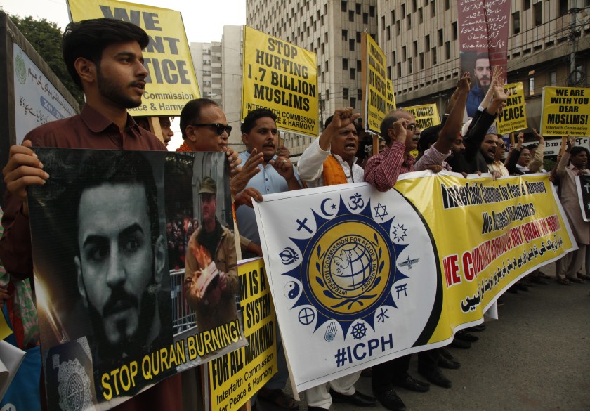 Supporters of Interfaith Commission for Peace and Harmony condemn a desecration of the Muslim Holy book Quran in the Norwegian city of Kristiansanda, in Karachi, Pakistan, Saturday, Nov. 23, 2019. (AP Photo)