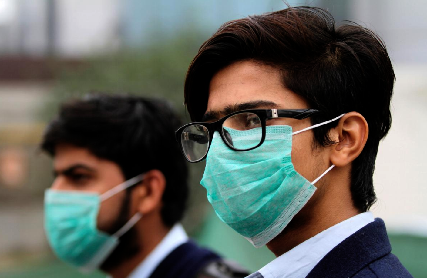 Men wearing protective masks wait for a bus in Lahore, Pakistan November 22, 2019. (REUTERS/ File Photo)