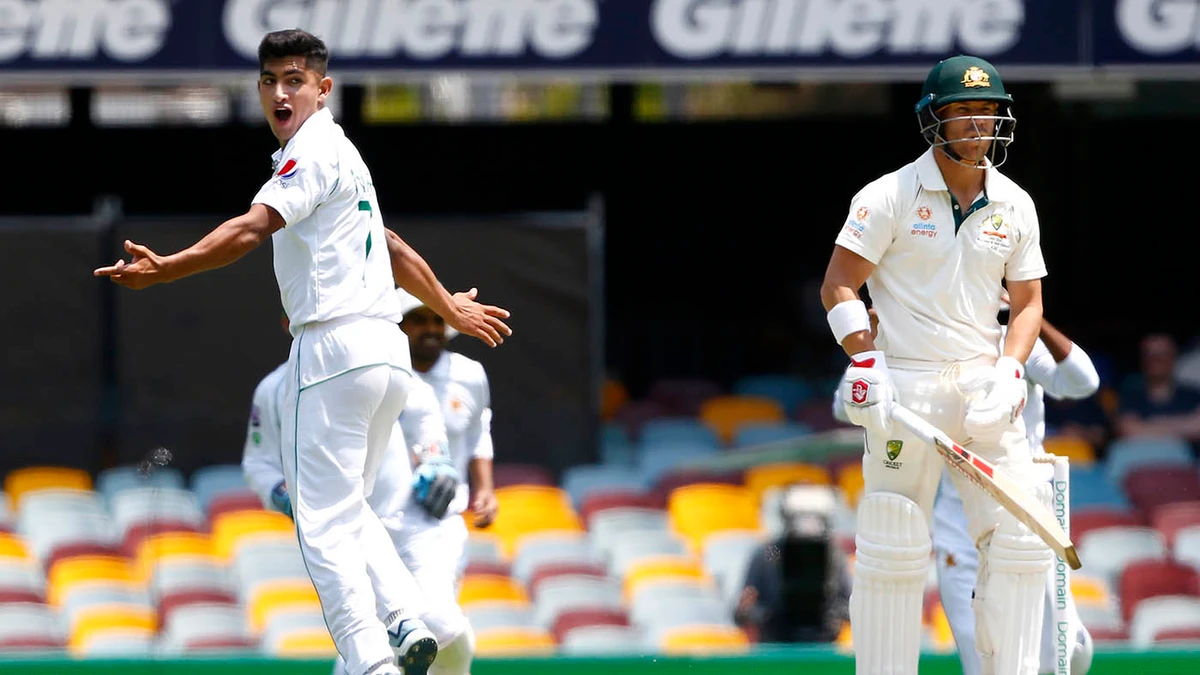 Pakistan's Naseem Shah, left, celebrates the wicket of Australia's David Warner before the decision was overturned due to a no ball called during their cricket test match in Brisbane on Nov. 22, 2019. (AP)
