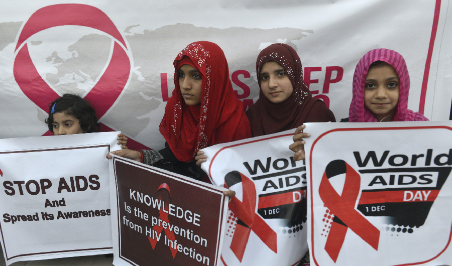 Pakistani social activists carry placards during a rally to raise awareness on World AIDS Day in Lahore on December 1, 2016. (AFP)