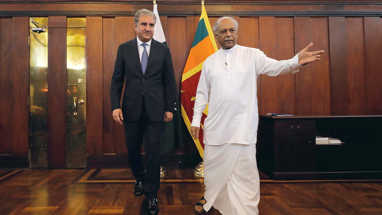 Pakistan’s Foreign Minister Shah Mahmood Qureshi, left, arrives with his Sri Lankan counterpart Dinesh Gunawardena during his two-day official visit in Colombo on Dec. 2, 2019. (REUTERS)