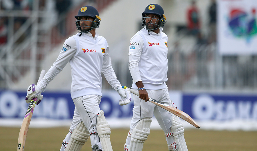 Sri Lankan batsmen Dhananjaya de Silva, left, and Dilruwan Perera walk back to pavilion after play stopped due to bad light conditions during the second-day of the 1st cricket test match between Pakistan and Sri Lanka, in Rawalpindi, Pakistan, Thursday, Dec. 12, 2019. (AP)