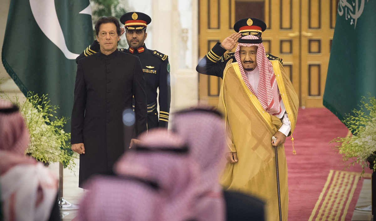 A handout image provided by the Center for International Communication (CIC), Ministry of Media, Kingdom of Saudi Arabia, on September, 20, 2018 shows Saudi King Salman, right, welcoming Pakistani Prime Minister Imran Khan, left, in Jeddah on Sept. 19, 2018. (CIC via AFP)