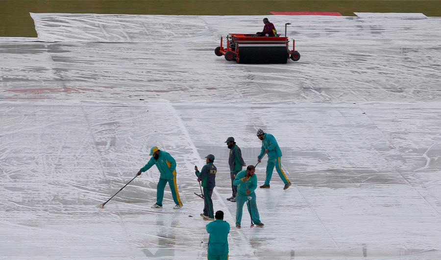Groundkeepers work to remove water from covers following overnight heavy rainfalls during the third-day of the first cricket test match between Pakistan and Sri Lanka, in Rawalpindi, Pakistan, Friday, Dec. 13, 2019. (AP)