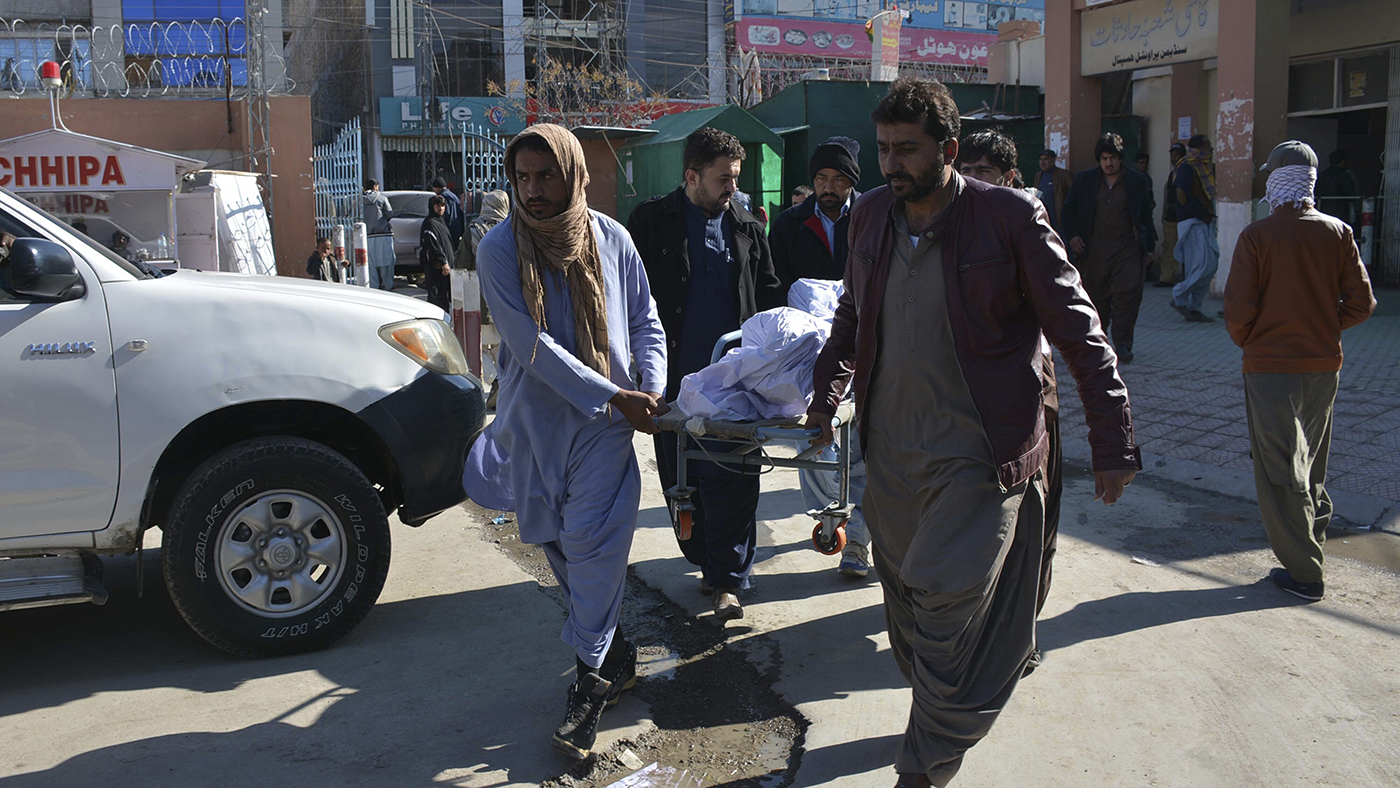Pakistani volunteers carry a body of an accident victim at a hospital in Quetta on Dec. 13, 2019. (AP)