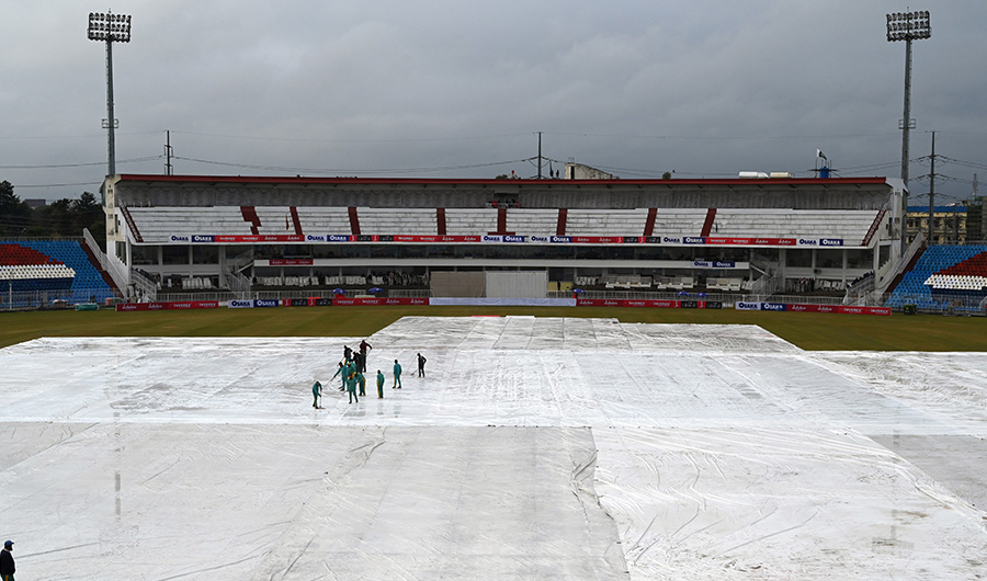 Ground staff remove rain water from the pitch during the fourth day of the first Test cricket match between Pakistan and Sri Lanka at the Rawalpindi Cricket Stadium in Rawalpindi on December 14, 2019. (AFP)