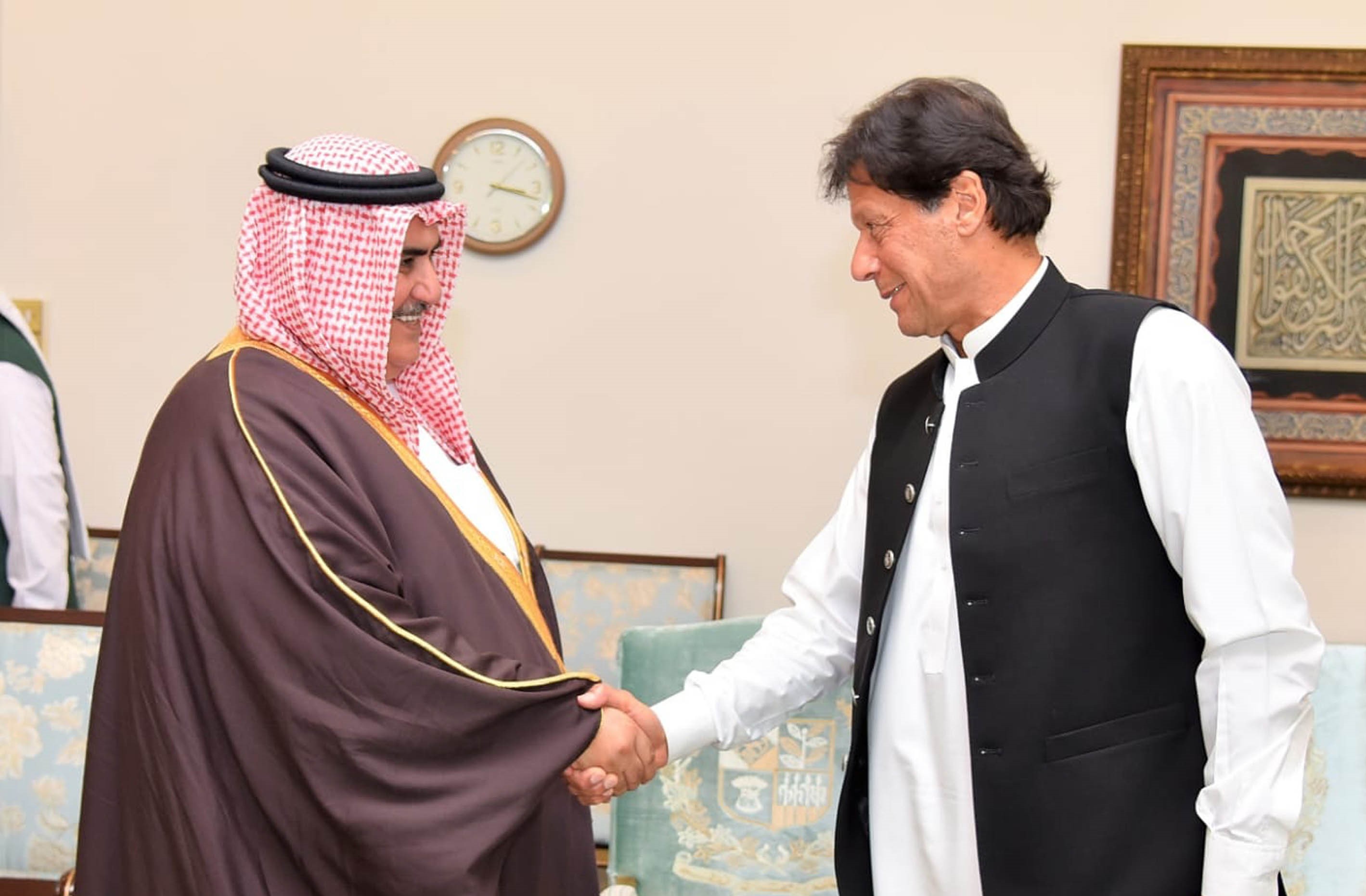 In this file photo, Prime Minister Imran Khan, right, greets Bahrain's Foreign Minister Shaikh Khalid bin Ahmed bin Mohamed Al Khalifa in Islamabad on April 9, 2019. (PID)