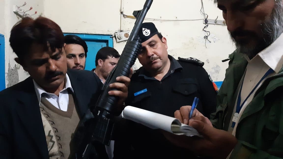 A security official inspects a seized weapon after Pakistani authorities impounded a truck attempting to smuggle weapons from Afghanistan into Pakistan via the Torkham border on Dec. 13, 2019. (Photo courtesy: KP Customs Department)
