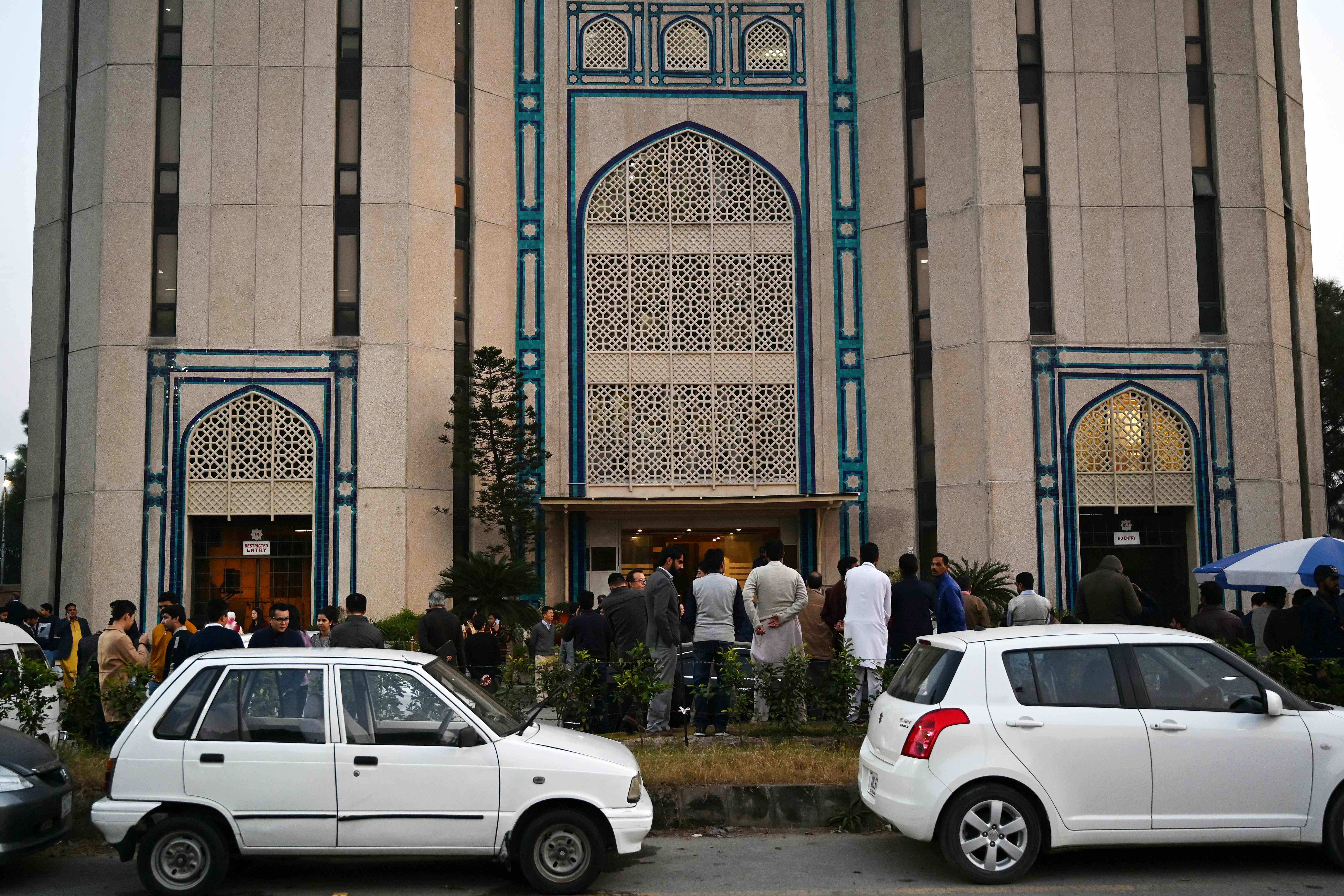 People gather outside buildings after a 6.1-magnitude earthquake in Islamabad on December 20, 2019. A strong earthquake rattled Afghanistan and Pakistan on December 20 afternoon, the US Geological Survey said, forcing residents into the streets in Islamabad and Kabul. (AFP)
