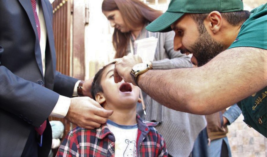 A KSRelief worker giving polio drops to a child in Pakistan on Dec 20, 2019. (Photo Courtesy: KSRelief Twitter)