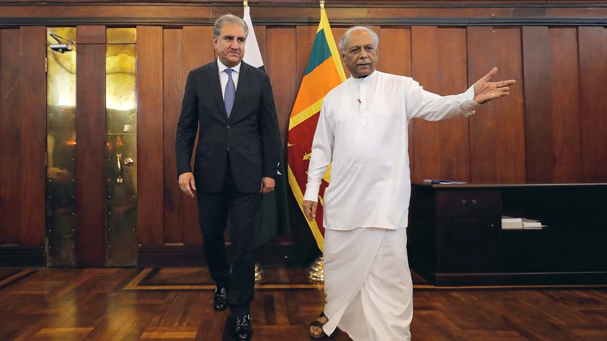 Pakistan’s Foreign Minister Shah Mahmood Qureshi, left, arrives with his Sri Lankan counterpart Dinesh Gunawardena during his two-day official visit in Colombo on Dec. 2, 2019. (REUTERS)