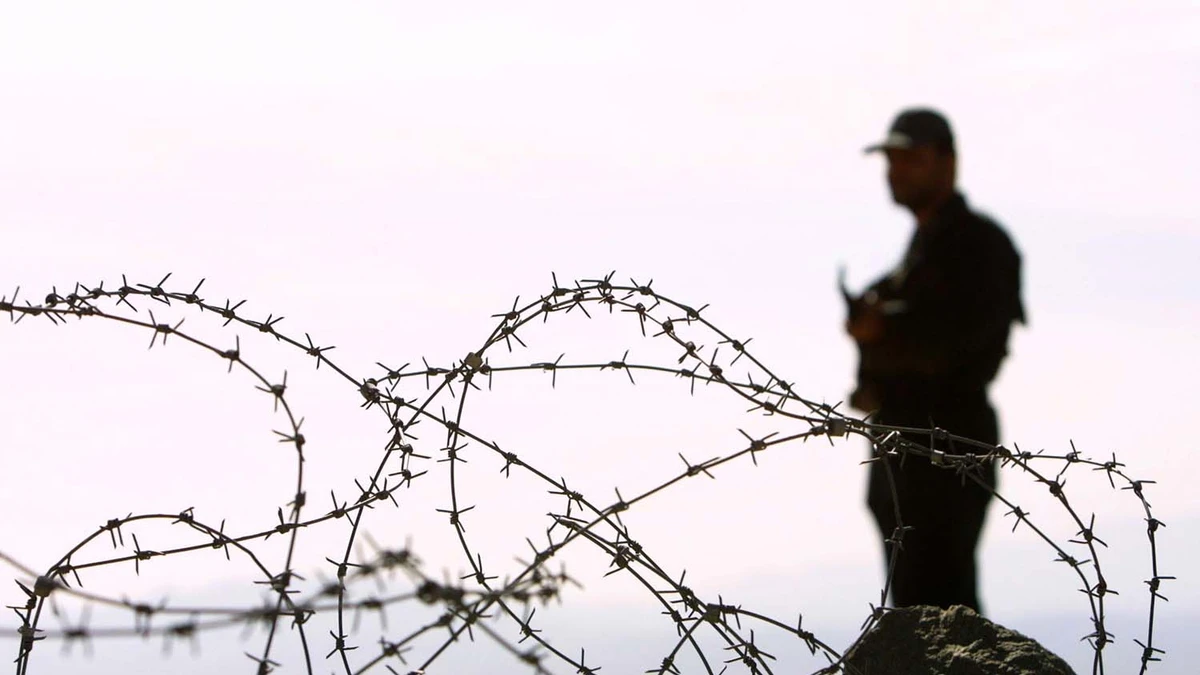 In this file photo, Iranian soldier stands guard on a mound built to prevent drug trafficking in the Mirjaveh point where the borders of Iran, Afghanistan and Pakistan meet, on Dec. 2003. (AFP)