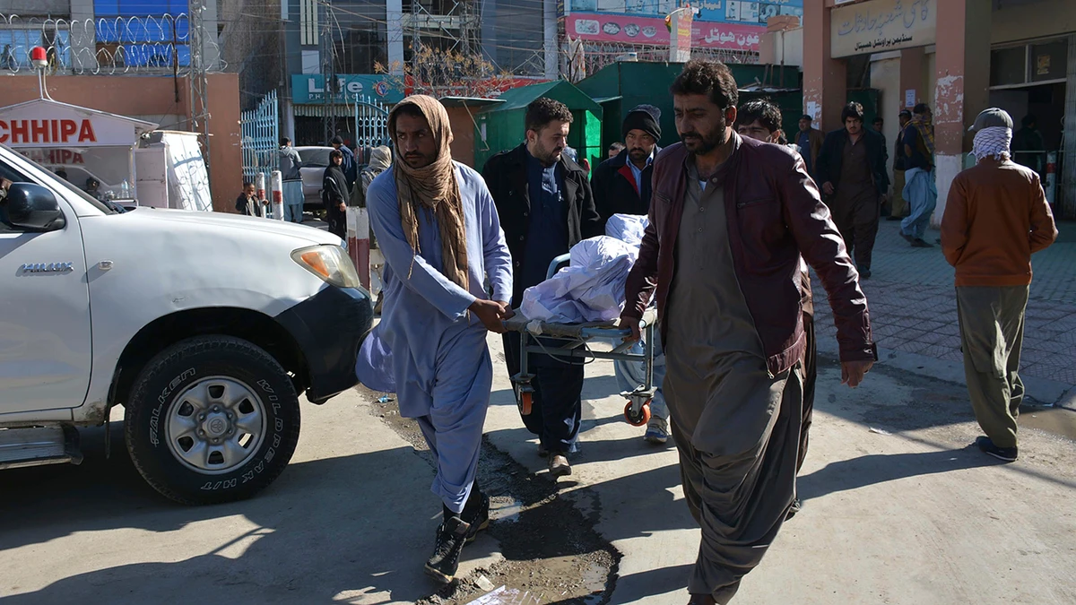 Pakistani volunteers carry a body of an accident victim at a hospital in Quetta on Dec. 13, 2019. (AP)
