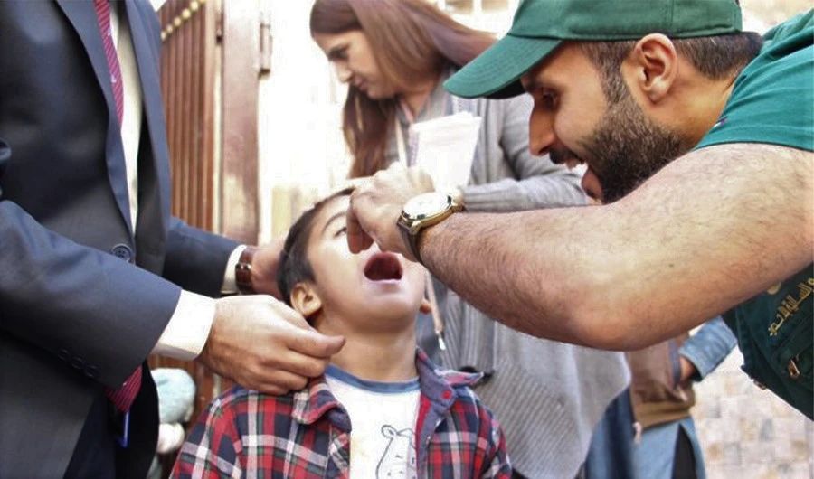 A KSRelief worker giving polio drops to a child in Pakistan on Dec 20, 2019. (Photo Courtesy: KSRelief Twitter)