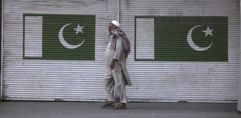 A man walks past a shop which is closed due to a strike in Peshawar, Pakistan, July 13, 2019. (AP Photo)
