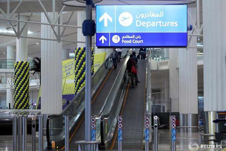 This file photo shows passengers on escalators at the airport in Dubai on Dec. 26, 2018. (REUTERS)