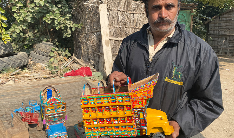 Shahnawaz Baloch, a farmer and artist, presents a handmade miniature truck at his home in Udasi village, Thatta district on Jan. 1, 2020. (AN photo)