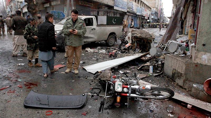 Police officers examine the site of a bomb explosion in Quetta, Pakistan, Jan. 7, 2020. A powerful roadside bomb exploded near a vehicle carrying security forces in the country's southwest. (AP Photo/Arshad Butt)
