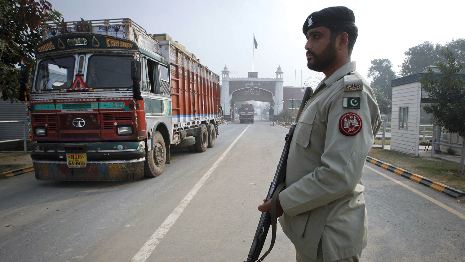 In this file photo, a paramilitary soldier stands guard as a truck crosses into Pakistan from India at the Wagah border. (REUTERS/File)