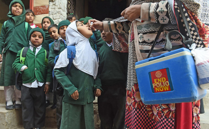 In this file photo, a Pakistani health worker administers polio vaccine drops to school children during a polio campaign in Lahore on Jan. 15, 2018. (AFP)