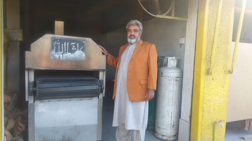 Sher Malik stands next to his automated tandoor plant on Jan. 16, 2020 in Mingora, the main town of Swat valley. (AN photo)