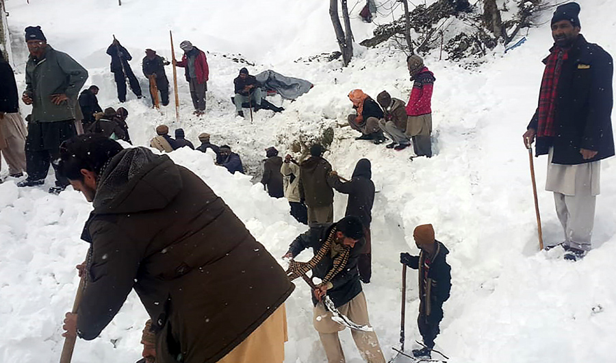 Local residents search for the avalanche victims in the snow in Neelum Valley, in Pakistan-administered Kashmir on January 15, 2020. (AFP)