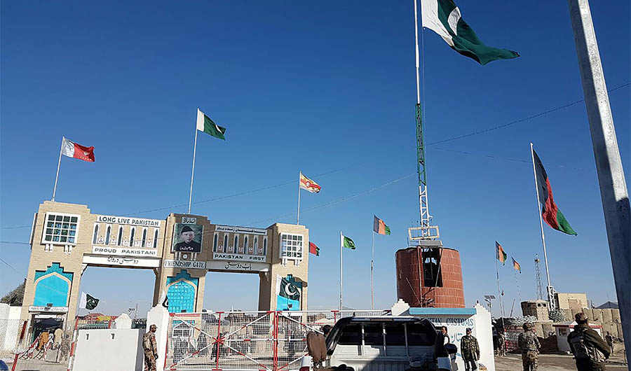 In this photograph taken on January 7, 2017, Pakistan security personnel look on as travellers wait to cross the border between Pakistan and Afghanistan at Chaman. (AFP)