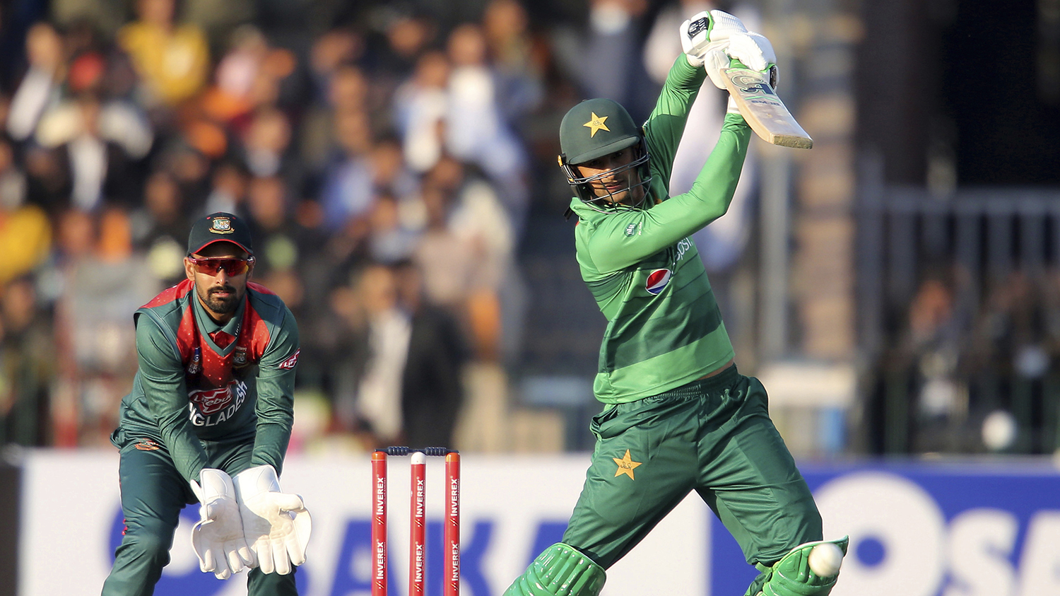 Pakistan’s Shoaib Malik plays boundary as Bangladeshi wicketkeeper Liton Das looks on at the Qaddafi Stadium in Lahore on Jan. 24, 2020. (AP)