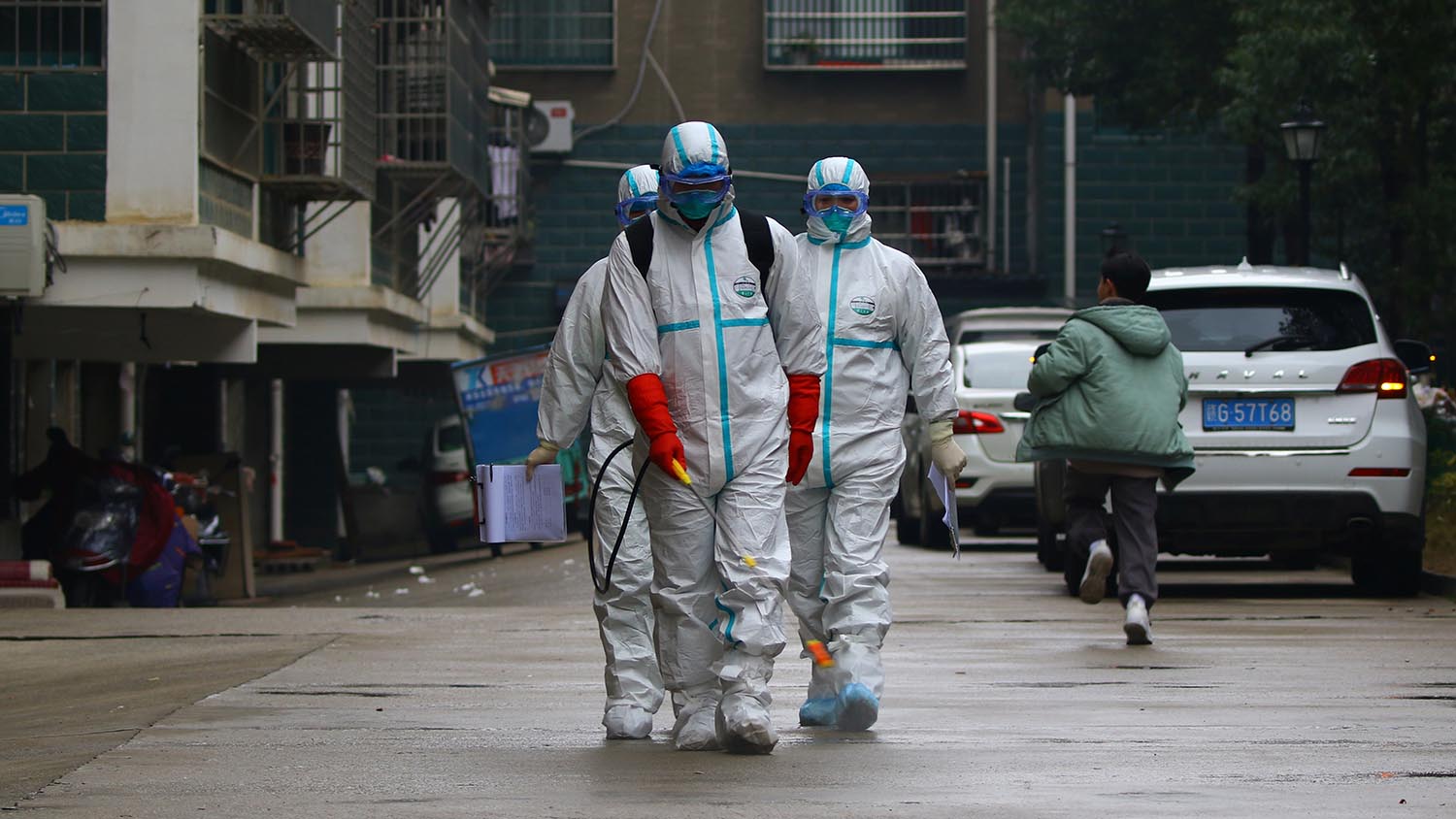 Workers from local disease control and prevention department in protective suits disinfect a residential area following the outbreak of a new coronavirus in China, Jan. 25, 2020. (CNSPHOTO via REUTERS)