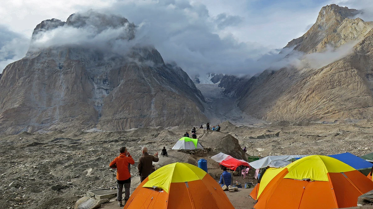 In this file photo, foreign tourists and porters rest at a camping site above Baltoro glacier in the Karakoram range of Pakistan's mountain northern Gilgit region on Aug. 12, 2019. (AFP)