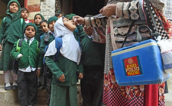 In this file photo, a Pakistani health worker administers polio vaccine drops to school children during a polio campaign in Lahore on Jan. 15, 2018. (AFP)