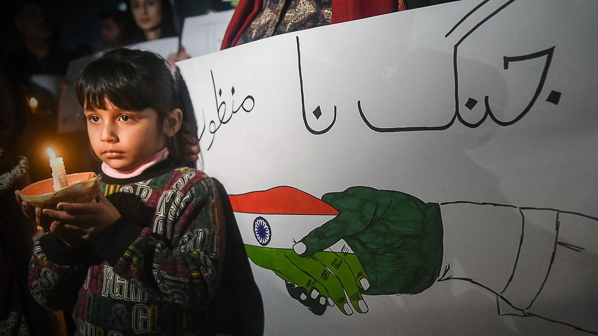 A Pakistani girl holds a candle during a vigil for peace between Pakistan and India in Lahore on March 3, 2019. (AFP)