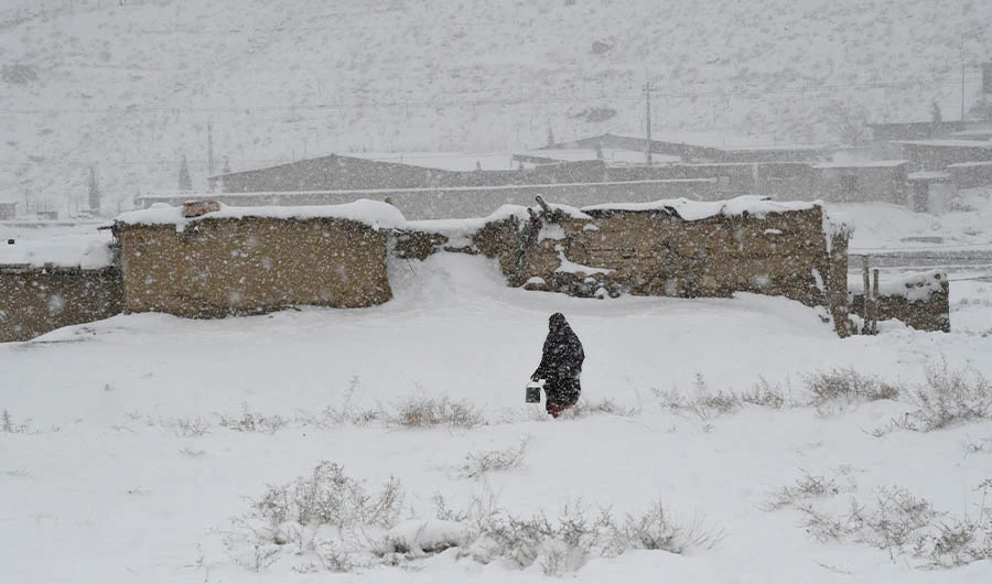 A woman walks during a snowfall in Quetta on January 12, 2020. (AFP)