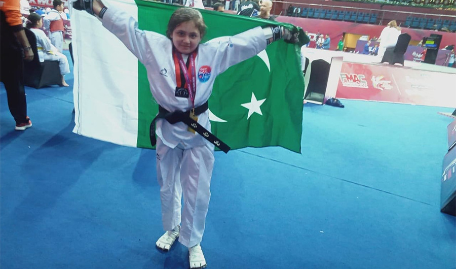 Ayesha Ayaz 9, a youngest Taekwondo girl athlete from Pakistan, holds a Pakistani flag on February 1, 2020. She wins gold medal in 34-KG at the 8th Fujairah Open Taekwondo Championship underway in the United Arab Emirates. (Photo courtesy: The Athlete)