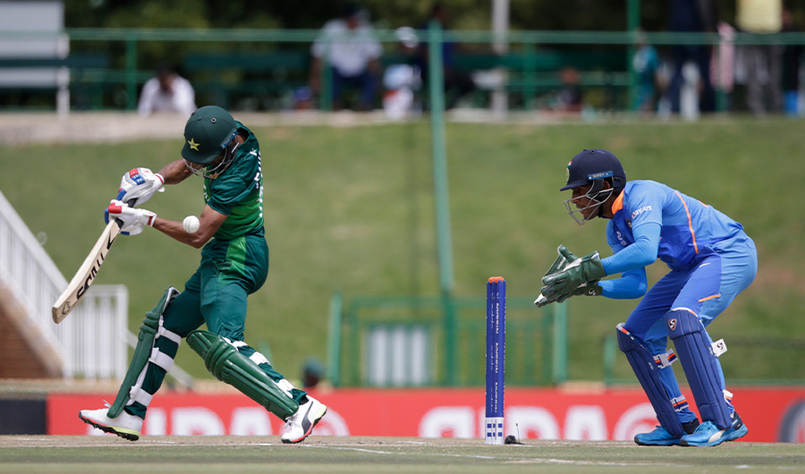 Pakistan's Fahad Munir (L) plays a shot as India's Dhruv Jurel (R) looks on during the Semi-Final of the ICC Under-19 Cricket World Cup between India and Pakistan at the Senwes Park in Potchefstroom on February 4, 2020. (AFP)
