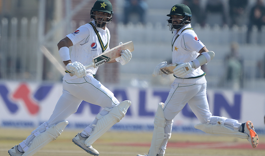 Pakistan's Shan Masood (L) and Azhar Ali runs between the wickets during the second day of the first cricket Test match between Pakistan and Bangladesh at the Rawalpindi Cricket Stadium in Rawalpindi on February 8, 2020. (AFP)