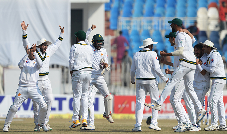 Pakistan's cricketers celebrate after the dismissal of Bangladesh's Rubel Hossain during the fourth day of the first cricket Test match between Pakistan and Bangladesh at the Rawalpindi Cricket Stadium in Rawalpindi on February 10, 2020. (AFP)