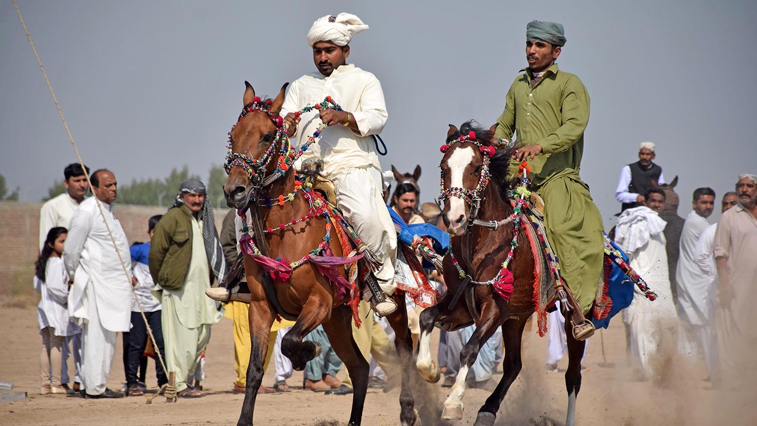 A horse race is underway at the first livestock expo in Sindh province's Hyderabad city on Feb. 9, 2020. (AN photo by S.A. Babar)