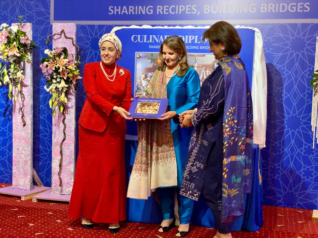 Ghada Ahmed, wife of the Egyptian ambassador, presents “Culinary Diplomacy: Sharing Recipes, Building Bridges” to First Lady Samina Alvi in Islamabad on Feb. 11, 2020. (AN photo)