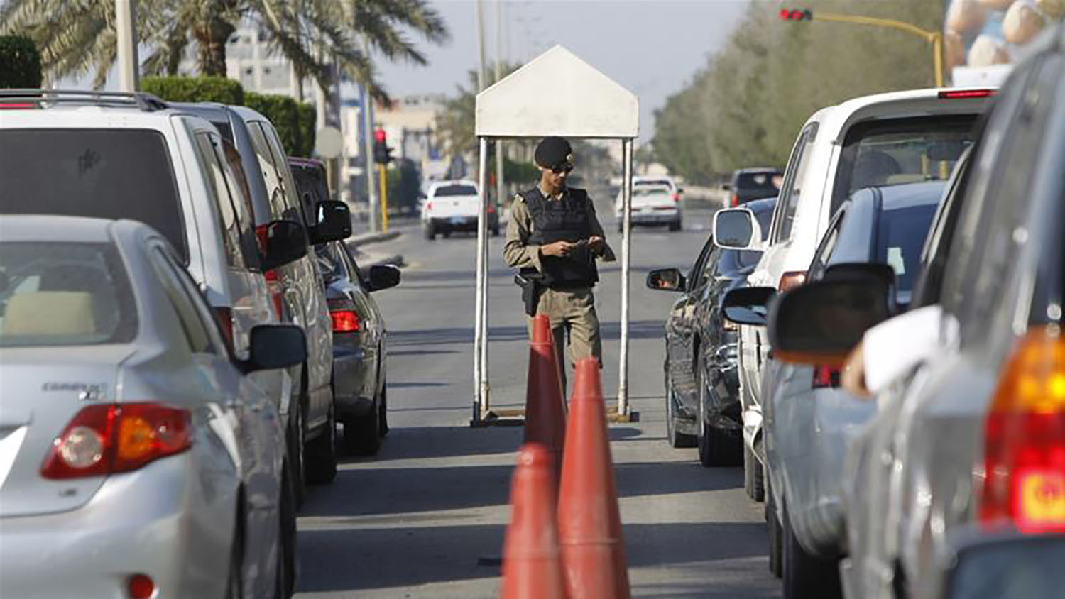 In this undated file photo, a Saudi police officer checks cars at a security checkpoint in Saudi Arabia's eastern Gulf coast town of Qatif. (REUTERS/File)