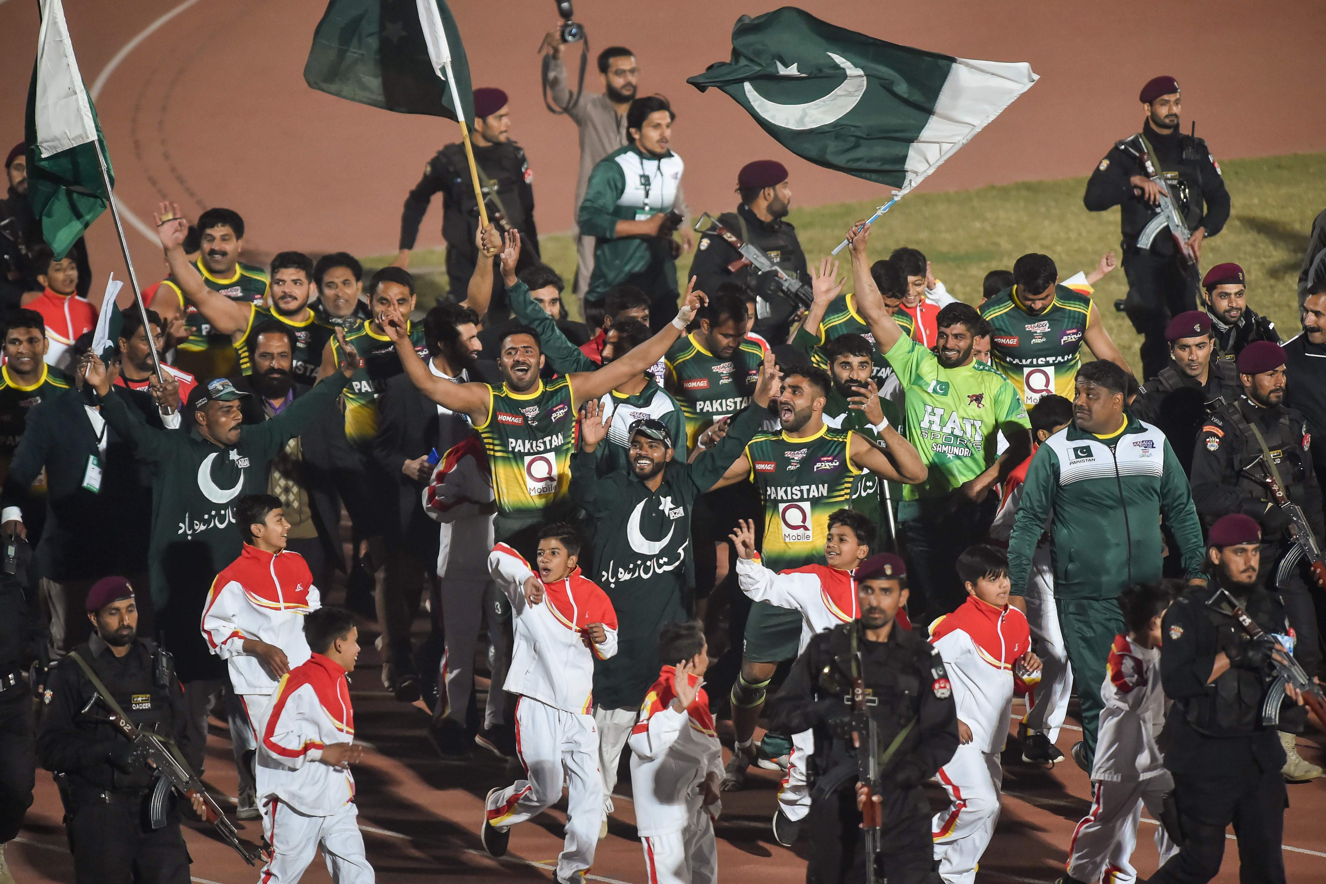 Pakistan's players wave Pakistan national flags as they celebrate after winning their final match in the Kabbadi World Cup 2020 against India in Lahore on February 16, 2020. (AFP)