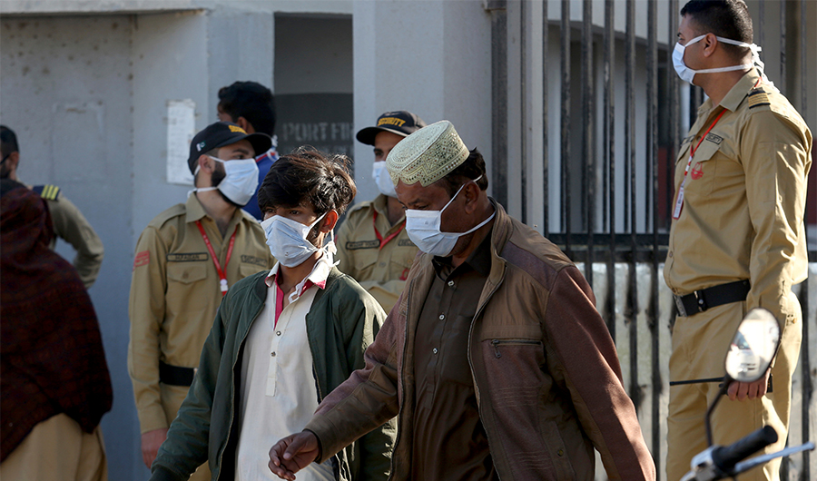 People and private guards wear masks while gather outside a hospital, where victims of toxic gas leak, are treated in Kamari neighborhood of Karachi, Pakistan, Monday, Feb. 17, 2020. A toxic gas leak killed five people and sickened dozens of others in a coastal residential area in Pakistan's port city of Karachi, police said Monday. The source of the leak, which occurred on Sunday night, and the type of gas that had leaked were not immediately known. There was no suspicion of sabotage. (AP)