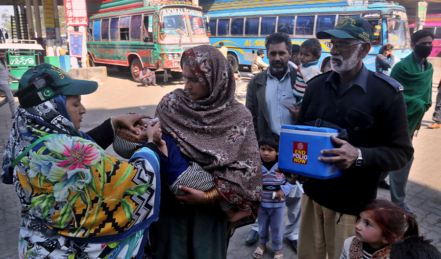 A health worker gives a polio vaccine to a child at a bus terminal in Lahore, Pakistan, Monday, Feb. 17, 2020. Pakistan government launched an anti-polio vaccination campaign in an effort to eradicate the crippling disease affected children. (AP)