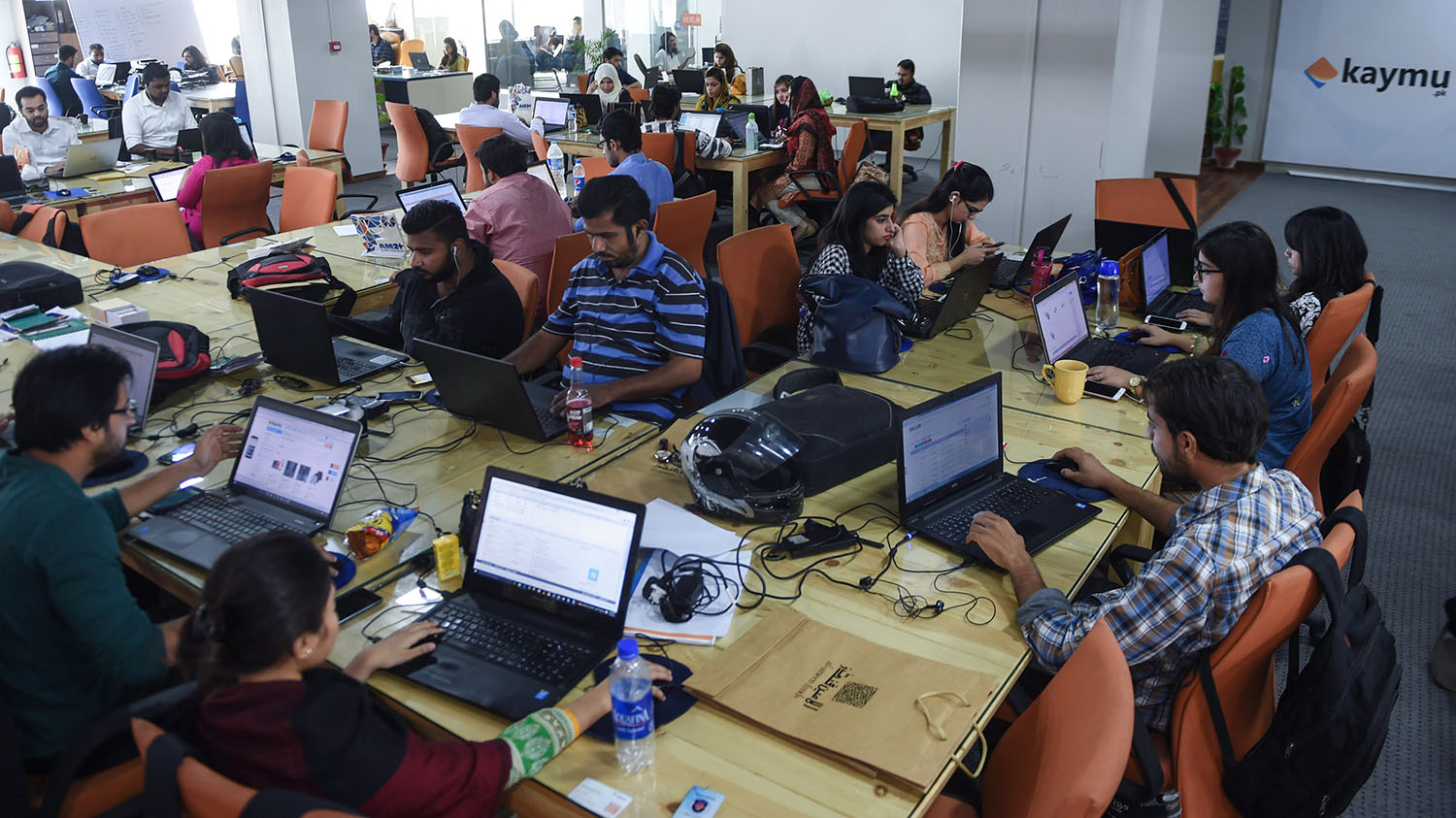 In this file photo, Pakistani employees of online marketplace company Kaymu seen at work in Karachi on Nov. 19, 2015. (AFP)
