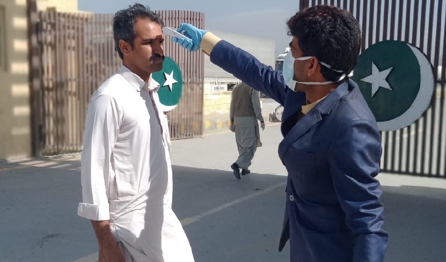 A Pakistan health official screens a man at the Taftan border crossing between the Pakistan-Iran border on Feb. 23, 2020, after coronavirus killed eight in Iran. Pakistan on Saturday declared a health emergency along its border with Iran. (Photo Courtesy: Office of the assistant commissioner Taftan)
