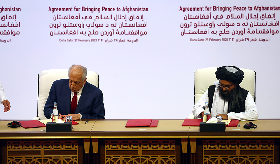 Mullah Abdul Ghani Baradar, the leader of the Taliban delegation, signs an agreement with Zalmay Khalilzad, U.S. envoy for peace in Afghanistan, at a signing agreement ceremony between members of Afghanistan's Taliban and the U.S. in Doha, Qatar February 29, 2020. (REUTERS)