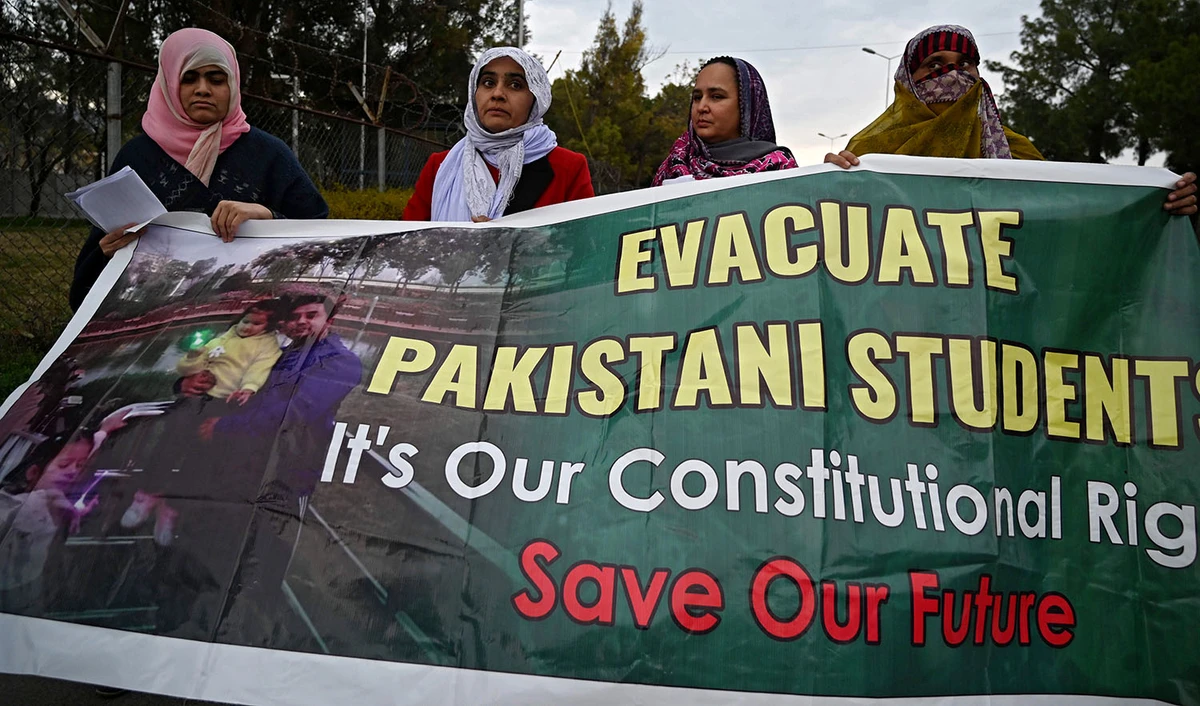 Parents and relatives of Pakistani students in the Chinese city of Wuhan, where the outbreak of the COVID-19 coronavirus began, hold placards during a protest to demand Pakistan's government the evacuation of their loved ones in Islamabad on Feb. 19, 2020. (AFP)