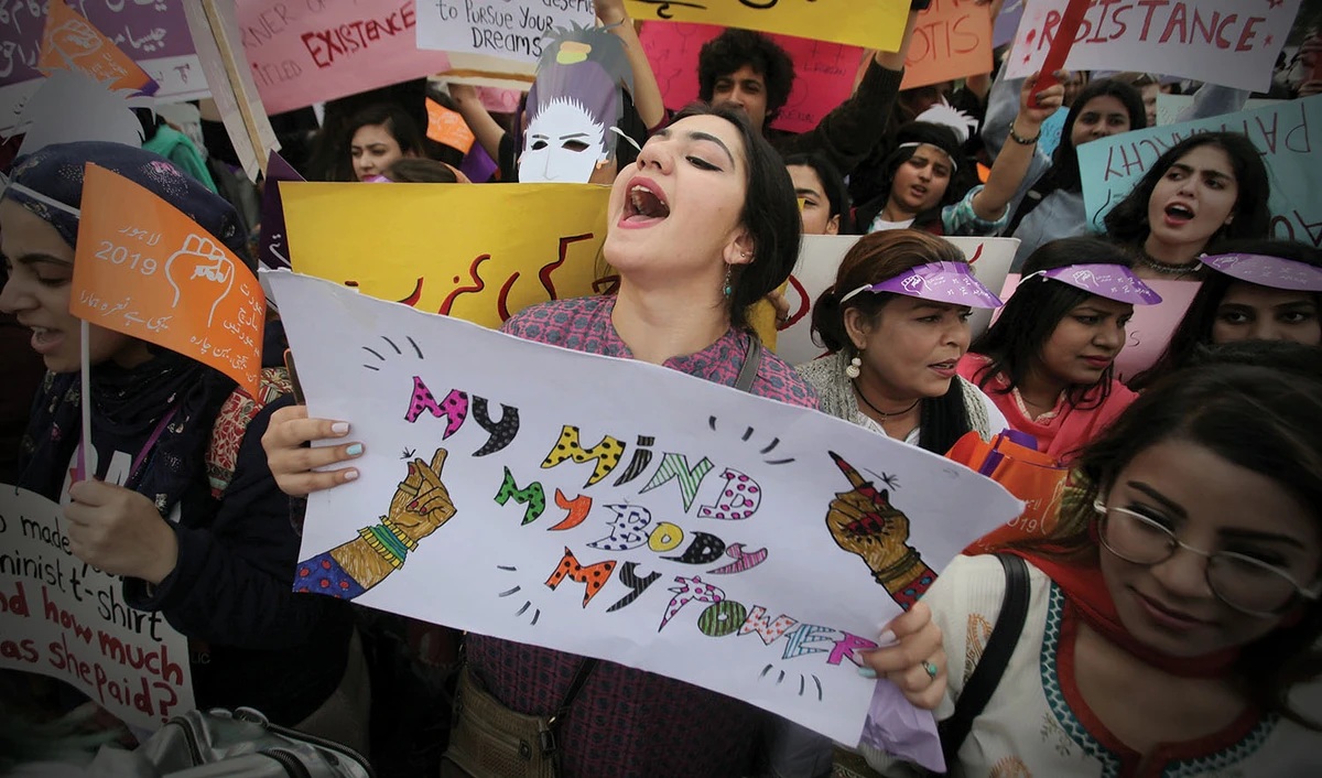 In this file photo, a woman carries a sign and chants slogans during a rally to mark International Women's Day in Lahore on March 8, 2019. (REUTERS)