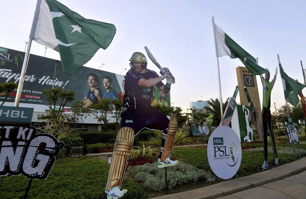 In this Saturday, Feb. 15, 2020, photo, a cut-out of a cricketer Shane Watson of Australia, on Feb. 15, 2020, displays along roadside in Karachi, Pakistan. Security concerns stopped foreign cricketers from touring Pakistan four years ago when the country's premier domestic Twenty20 tournament was launched, forcing organizers to stage the event on neutral turf in the United Arab Emirates. In 2020 edition of the PSL in Karachi which started on Thursday Feb 20, 2020, Darren Sammy of the West Indies and Shane Watson of Australia were among 36 foreign cricketers involved in the six franchises. (AP Photo)