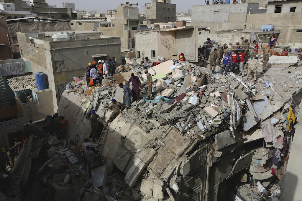 Pakistani volunteers look for survivors amid the rubble of a collapsed building in Karachi, Pakistan, Thursday, March 5, 2020. (AP)